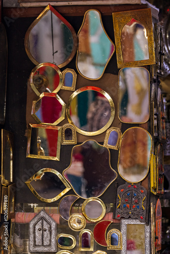 Close-Up of Handcrafted Brass Mirrors on a Metal Wall in Marrakech Medina photo