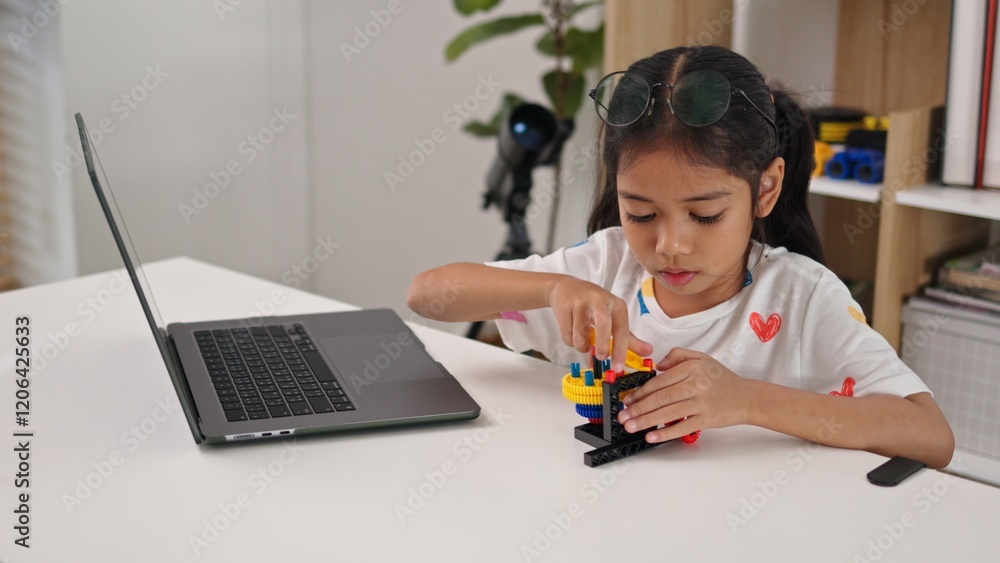 STEM education concept. Asian home school girls self-study online lessons and are excited to make STEM toys. mathematics engineering science technology computer code in robotics for kids' concepts. STEM education concept. Asian home school girls self-study online lessons and are excited to make STEM toys. mathematics engineering science technology computer code in robotics for kids' concepts.
