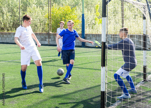 Defender tackles the ball in the penalty area. Soccer game photo