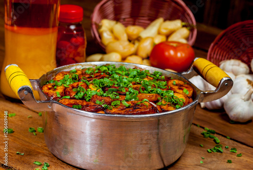 Comida brasileira na panela com arroz, carne, banana frita e temperos photo