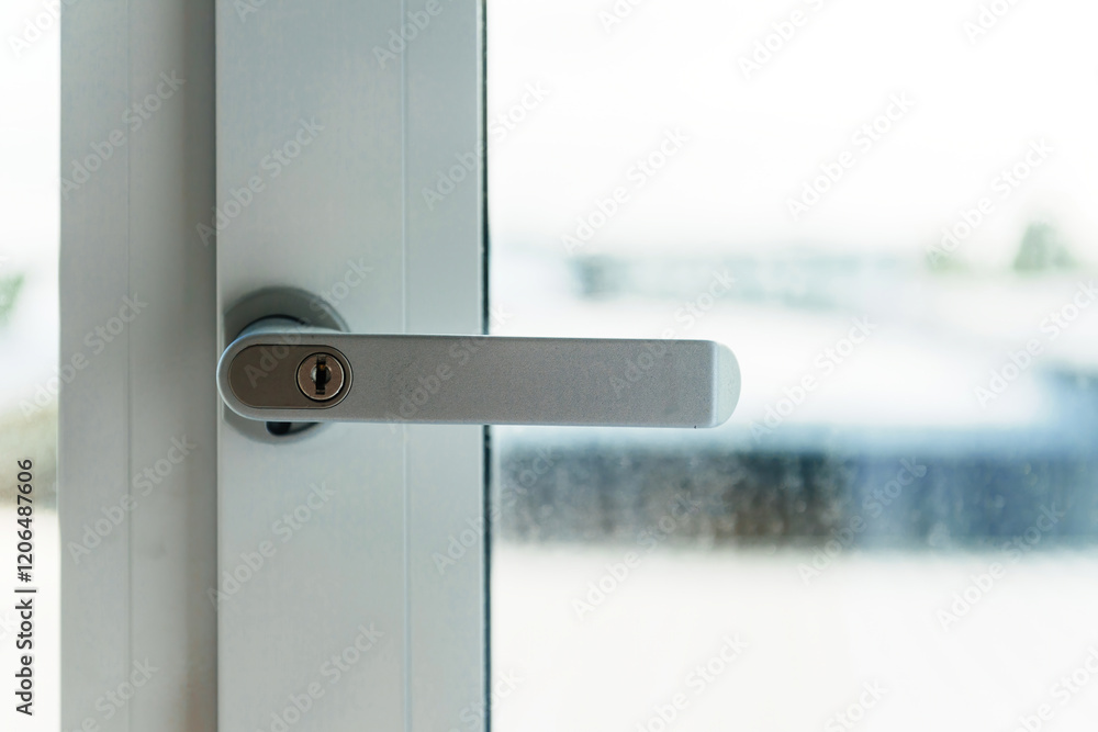 High-quality close-up of a sleek, silver PVC window handle with a secure locking mechanism, showcasing durability and premium craftsmanship. High-quality close-up of a sleek, silver PVC window handle with a secure locking mechanism, showcasing durability and premium craftsmanship.