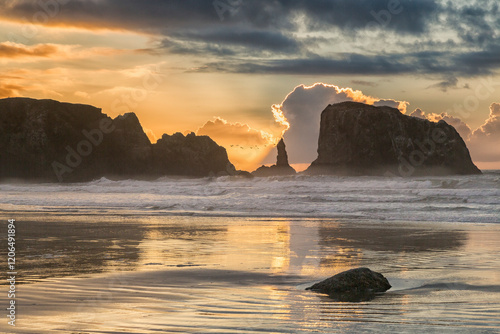 Beautiful photographic Bandon Oregon beach coast famous for drift wood cluttered coastline and rock formations	and evening sunsets