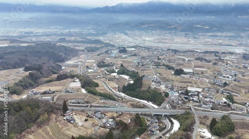 Aerial photography of highways and countryside in Iida City, Nagano Prefecture, Japan with snow on cold winter day in January 2025 using drone