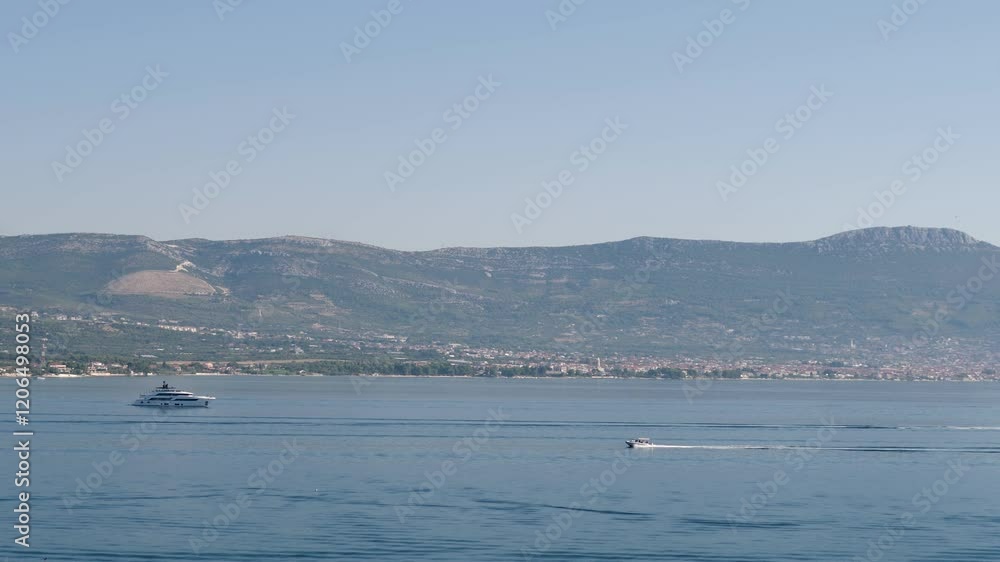 A Breathtaking Scenic Coastal View Featuring Boats With Hills in the Distant Background