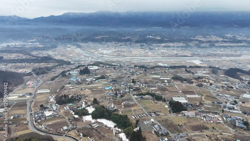 Aerial photography of highways and countryside in Iida City, Nagano Prefecture, Japan with snow on cold winter day in January 2025 using drone photo