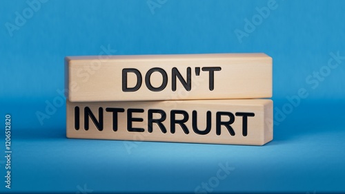 Dont interrupt symbol. Concept word Dont interrupt on wooden blocks. Business and Dont interrupt concept. Copy space.3D rendering on blue background.