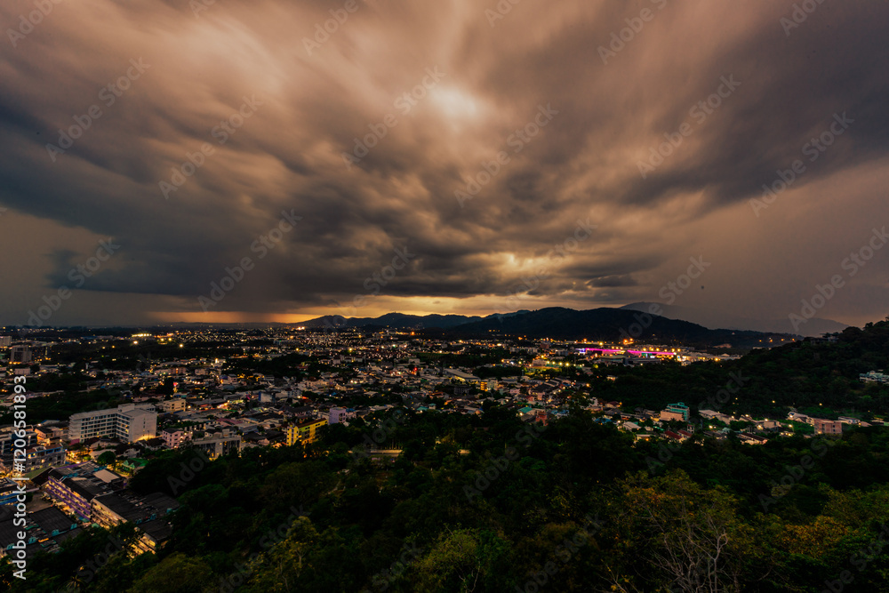 Nature background from Phuket city viewpoint, Khao Rang viewpoint, with black rain clouds covering the evening, changing seasons according to the time of the rainy season. Nature background from Phuket city viewpoint, Khao Rang viewpoint, with black rain clouds covering the evening, changing seasons according to the time of the rainy season.
