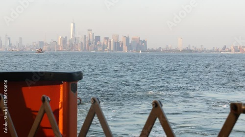 New York City skyline from ferry boat to Staten Island. Manhattan downtown. World Trade Center skyscraper from ferryboat. River waterfront sunset panorama, riverfront buildings architecture, FiDi, USA