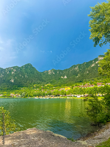 Serene Lake Idro Surrounded by Majestic Mountains and Cloudy sky, Italy, Crone photo