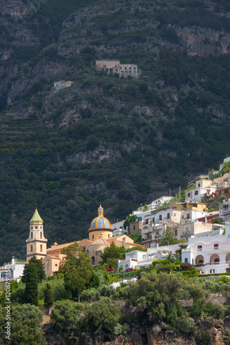 A picturesque village with a Catholic cathedral on the side of a mountain in Italy on the Amalfi Coast