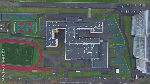 Aerial top view of the school with stadium and outdoors sports infrastructure.