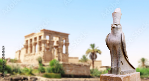 Horizontal banner with granite statue of falcon God Horus, palm and ancient columns, Karnak Temple Complex, Luxor (ancient Thebes), Egypt, North Africa photo