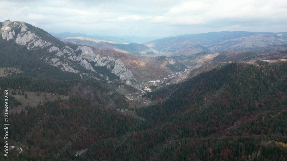 Autumn sun shining over the peaceful settlement located at the feet of the Carpathian Mountains. Aerial drone close up Autumn sun shining over the peaceful settlement located at the feet of the Carpathian Mountains. Aerial drone close up