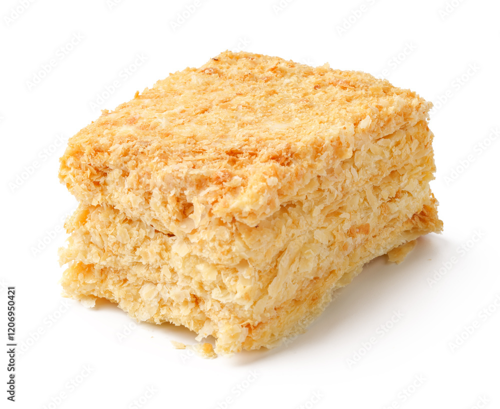 Delicious layered dessert made from finely grated coconut and creamy filling served on a white plate Delicious layered dessert made from finely grated coconut and creamy filling served on a white plate