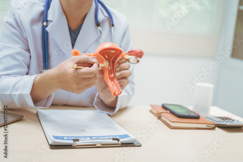 Male doctor treating female uterine diseases at hospital table, discussing uterine disease models,diagnosing uterine tumors, endometriosis,bacterial vaginitis,cervical cancer,HPV-related infections