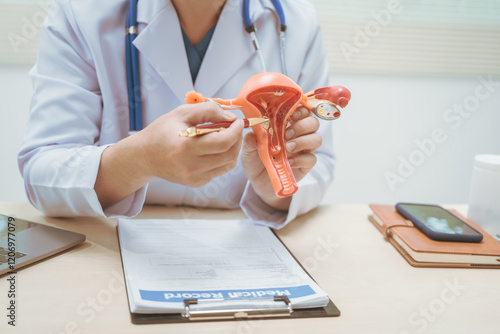 Male doctor treating female uterine diseases at hospital table, discussing uterine disease models,diagnosing uterine tumors, endometriosis,bacterial vaginitis,cervical cancer,HPV-related infections