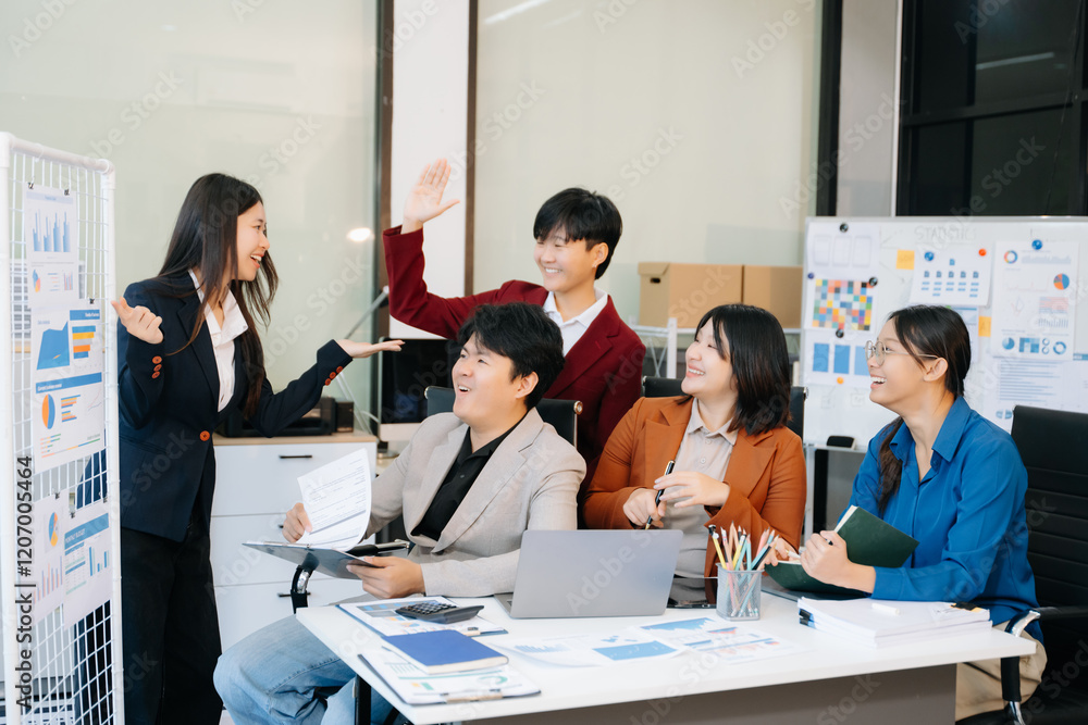 Fototapeta premium Group of diverse businesspeople using a laptop and tablet in office.