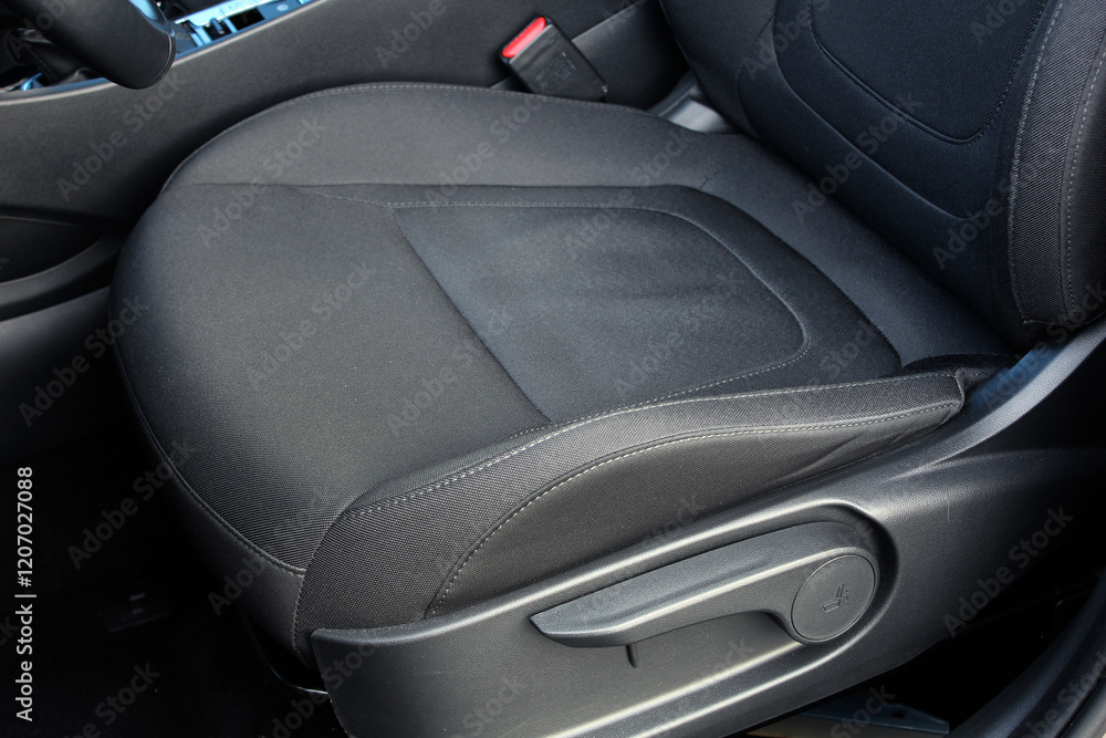 Driver seat of a new modern car. Textile car interior. Black leather drivers seat in a car. Front seats of a modern passenger car. Driver seat of a new modern car. Textile car interior. Black leather drivers seat in a car. Front seats of a modern passenger car.