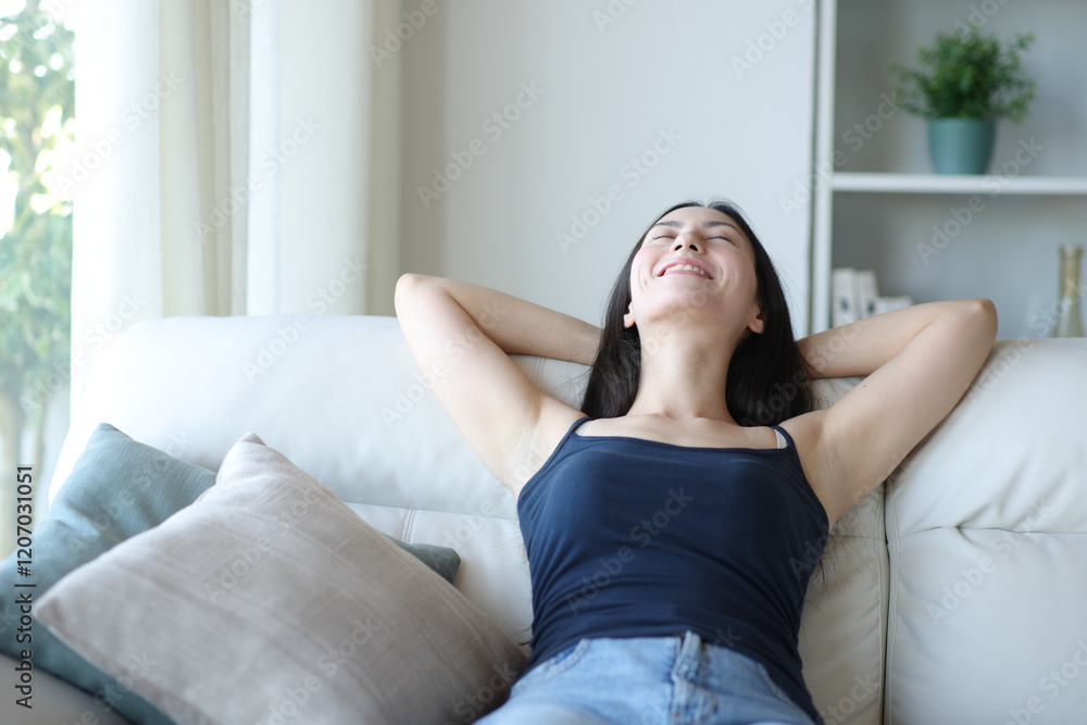 Happy relaxed asian woman resting sitting at home Happy relaxed asian woman resting sitting at home