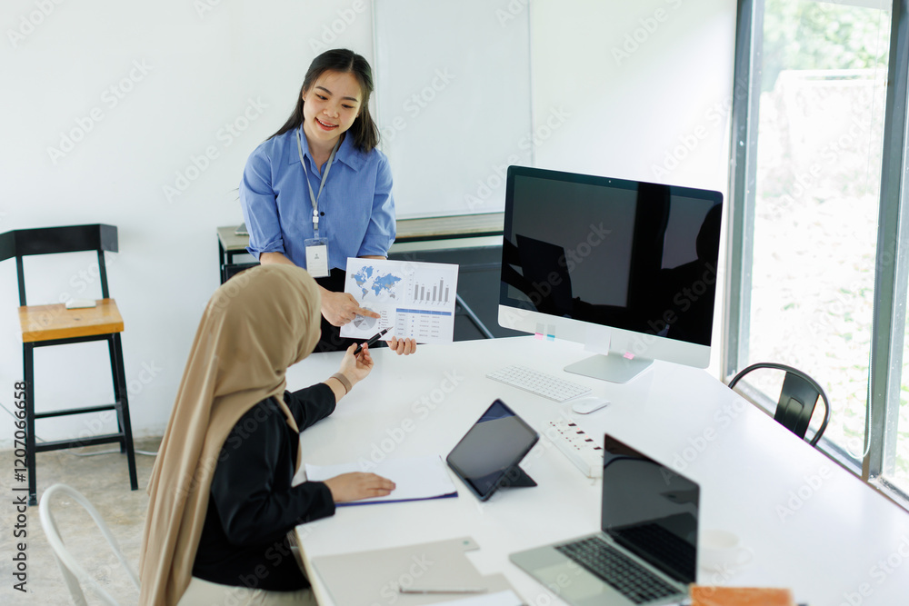 Young businesswoman adviser standing in front of laptop and giving advise to sales woman. Business people consulting at office. asian teamwork concept.
Young businesswoman adviser standing in front of laptop and giving advise to sales woman. Business people consulting at office. asian teamwork concept.