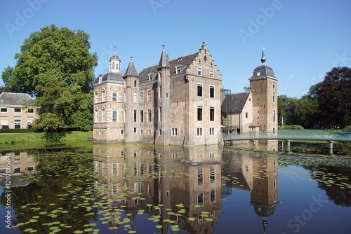 Dutch Castle surrounded by a water moat near the village of Ruurlo in the province of Gelderland, Netherlands photo