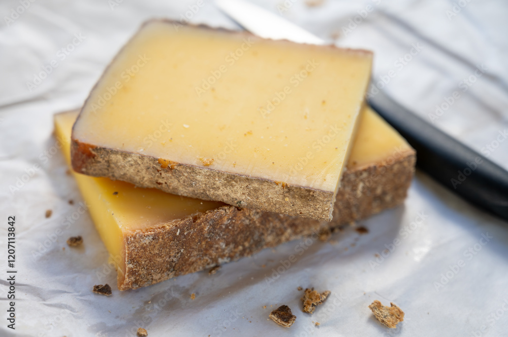 French cheese Comte, varieties unpasteurised ed milk Prestige, fruity flavoured Fruite and Vieille Reserve close up French cheese Comte, varieties unpasteurised ed milk Prestige, fruity flavoured Fruite and Vieille Reserve close up