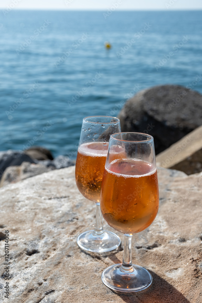 Drinking rose champagne or cava sparkling wine in Puerto Banus in Marbella, Spain. Sandy beaches, luxury yacht harbour in Costa del Sol, Andalusia. Drinking rose champagne or cava sparkling wine in Puerto Banus in Marbella, Spain. Sandy beaches, luxury yacht harbour in Costa del Sol, Andalusia.