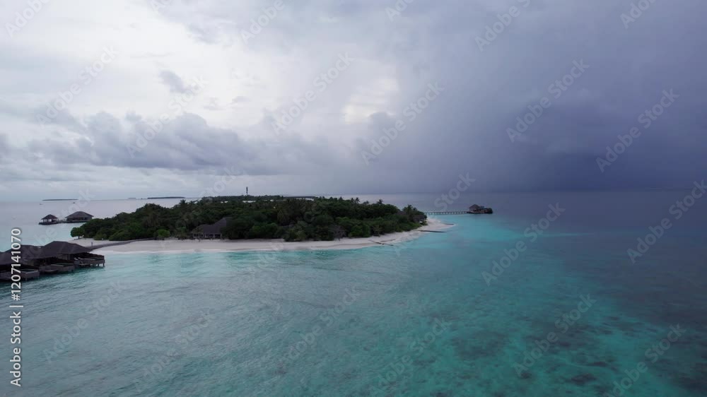 A storm with rain is coming to an island in the ocean. The gradient of sea water is from turquoise to dark blue. A green island with trees and palm trees. White sand. Clear water. Top view from drone A storm with rain is coming to an island in the ocean. The gradient of sea water is from turquoise to dark blue. A green island with trees and palm trees. White sand. Clear water. Top view from drone