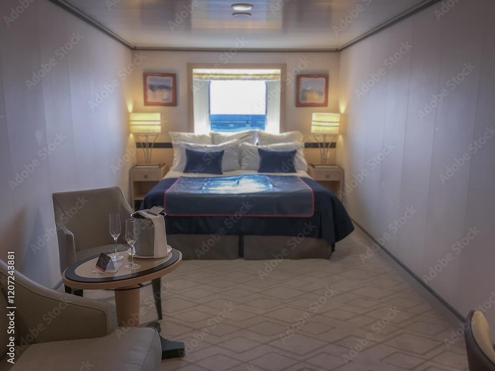 Luxurious oceanview outside or exterior ocean view cabin stateroom on luxury ocean cruiseship or cruise ship liner in modern interior design with king queen double bed