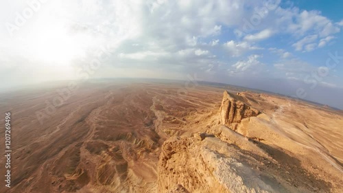 360 Panoramic view of the stunning Jebel fihrayn, or edge of the world, revealing dramatic cliffs and a vast desert landscape beneath a cloudy sky in Riyadh, Saudi Arabia photo