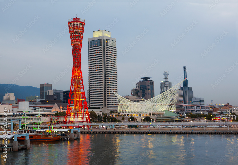 Kobe Port tower and maritime museum in the port of Kobe illuminated at dusk