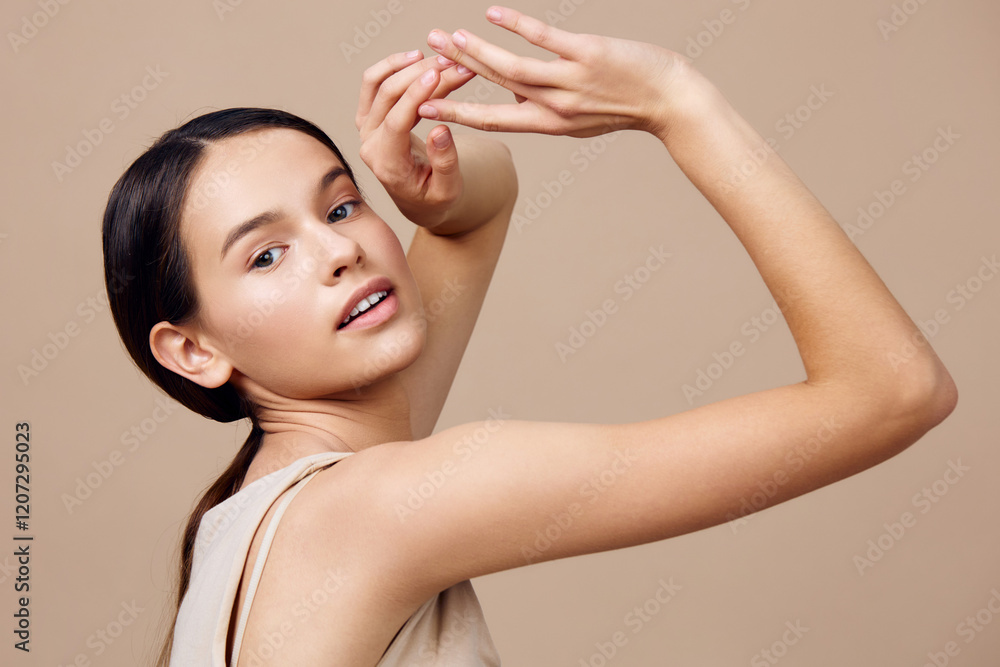 Elegant young model showcasing beauty and grace with a neutral background, emphasizing her natural skin tone and engaged expression Elegant young model showcasing beauty and grace with a neutral background, emphasizing her natural skin tone and engaged expression