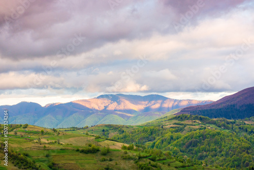 Obraz na płótnie mountain landscape in spring. highlands of ukraine. countryside scenery with rolling hills. sky with clouds in evening light. carpathian alps w salonie