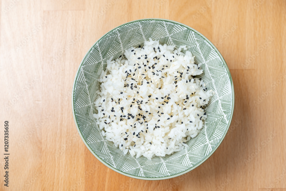 plain plate of steamed boiled basmati jasmine cooked rice on wooden table black sesame