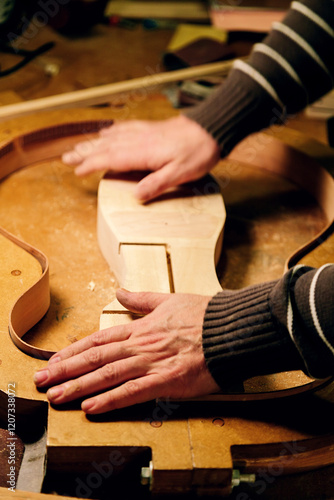 Crafting precision: artisan shaping bass guitar components photo