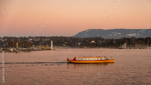 Yellow boat sailing on Lake Geneva at sunset with lighthouse view photo