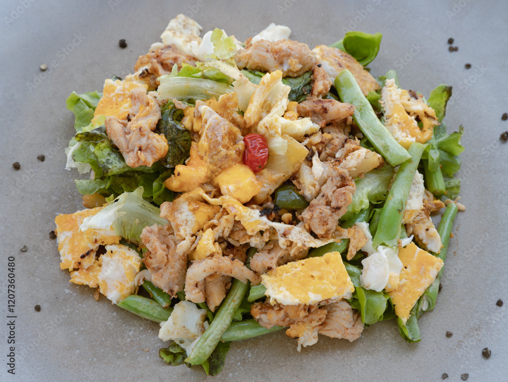 View of Homemade sliced chicken and fried egg, cherry tomatoes with salad featuring variety fresh green vegetables on round ceramic plate. Healthy eating lifestyle concept, use it as your Wallpaper.