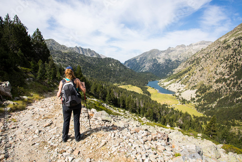 Young hiker woman in Vall de Boi, Aiguestortes and Sant Maurici National Park, Spain photo