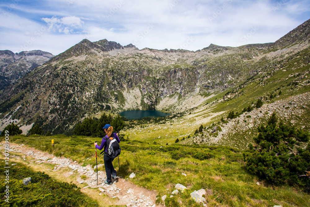 Young hiker woman in Vall de Boi, Aiguestortes and Sant Maurici National Park, Spain Young hiker woman in Vall de Boi, Aiguestortes and Sant Maurici National Park, Spain