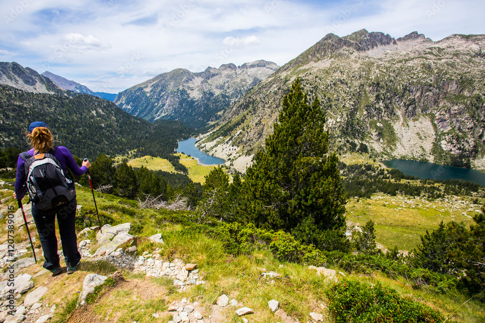 Fototapeta premium Young hiker woman in Vall de Boi, Aiguestortes and Sant Maurici National Park, Spain