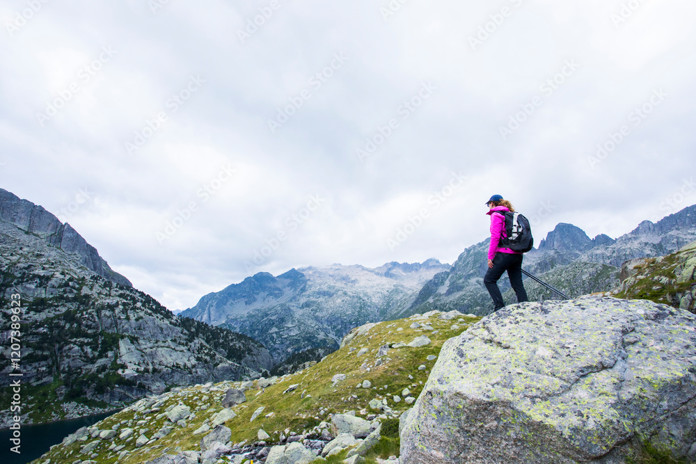 Young hiker woman in Vall de Boi, Aiguestortes and Sant Maurici National Park, Spain Young hiker woman in Vall de Boi, Aiguestortes and Sant Maurici National Park, Spain