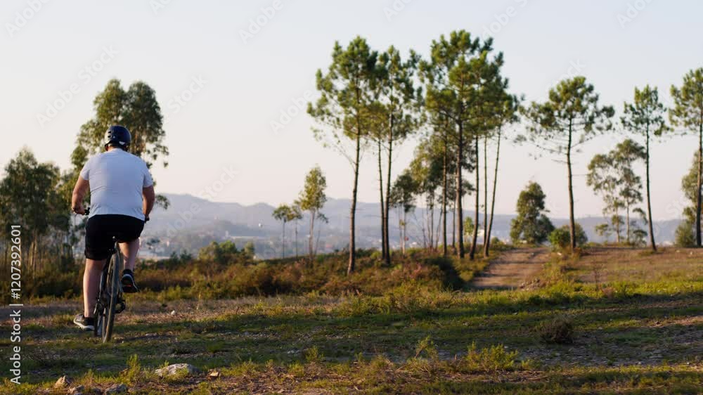 A cyclist rides on a dirt path surrounded by scenic pine trees under a clear sky. The dynamic scene captures the essence of outdoor exploration. A cyclist rides on a dirt path surrounded by scenic pine trees under a clear sky. The dynamic scene captures the essence of outdoor exploration.
