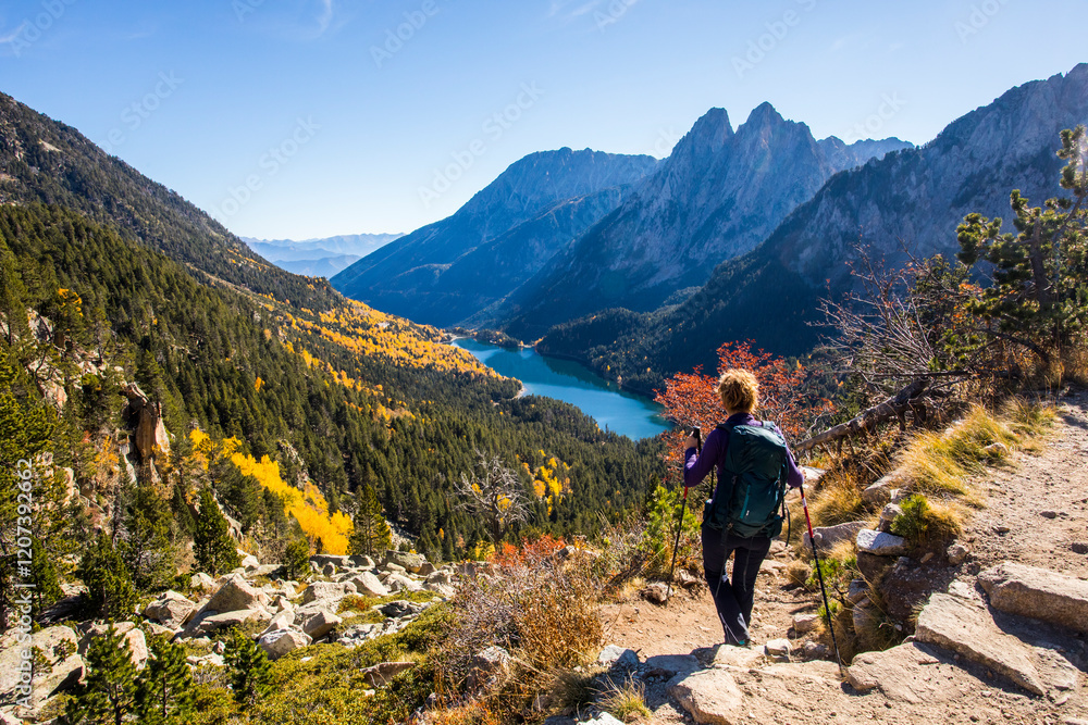 Young hiker woman in autumn in Aiguestortes and Sant Maurici National Park, Spain Young hiker woman in autumn in Aiguestortes and Sant Maurici National Park, Spain