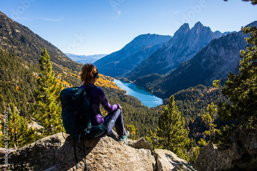 Young hiker woman in autumn in Aiguestortes and Sant Maurici National Park, Spain photo