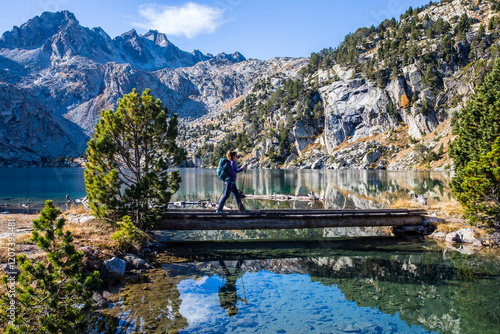 Young hiker woman in autumn in Aiguestortes and Sant Maurici National Park, Spain photo