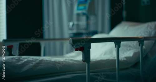 Hospital room showing an unoccupied bed with clean linens.