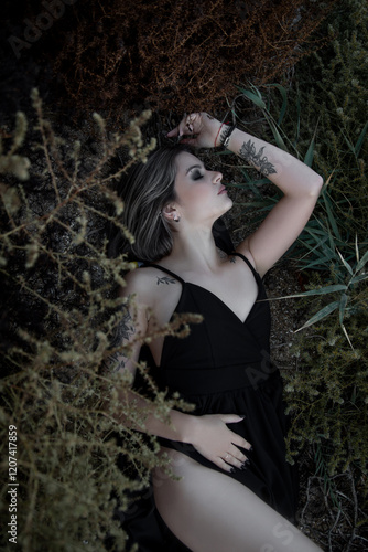 Portrait of a beautiful girl with bright makeup and beautiful hair, sitting with her back to the camera. photo