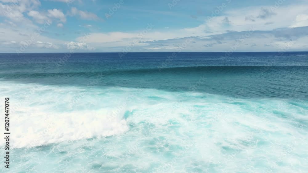 Slow motion smooth aerial pullback of foamball from crashing wave glistening on fringing coral reef Slow motion smooth aerial pullback of foamball from crashing wave glistening on fringing coral reef