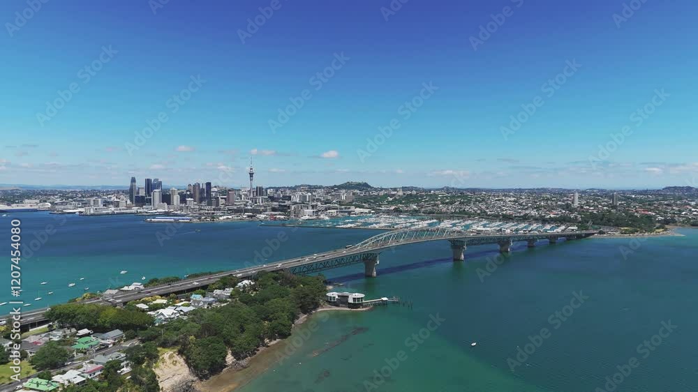 Aerial view of the Harbour Bridge of Auckland with the city's skyline and Westhaven Marina in the background. Aerial view of the Harbour Bridge of Auckland with the city's skyline and Westhaven Marina in the background.