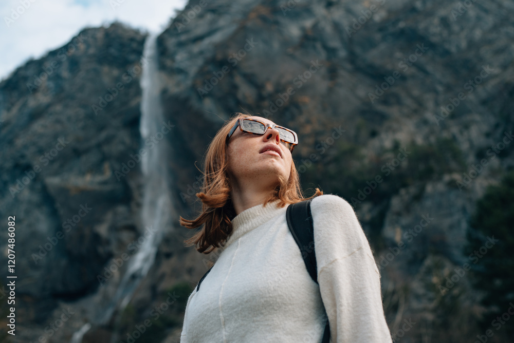 red-haired girl with a briefcase against the backdrop of mountains in France red-haired girl with a briefcase against the backdrop of mountains in France